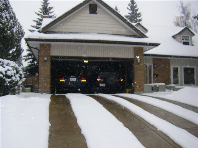 A heated driveway with four heated tire tracks.